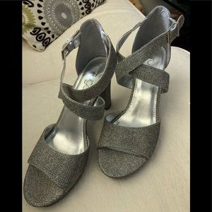 Silver iridescent cross front ankle strap.